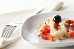 Catalonian codfish salad as known as "esqueixada", with cod, tomato and pepper.